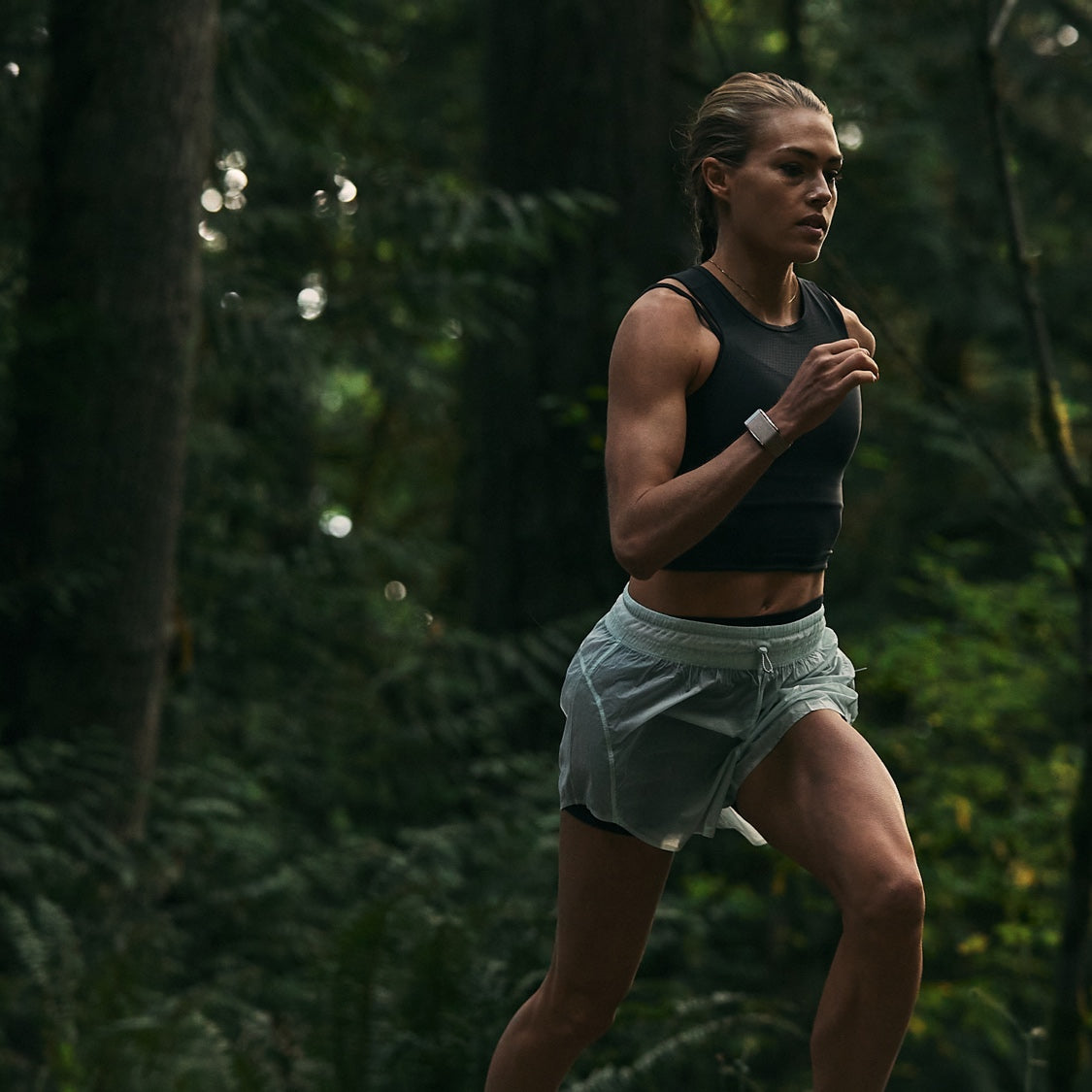 woman jogging through the woods