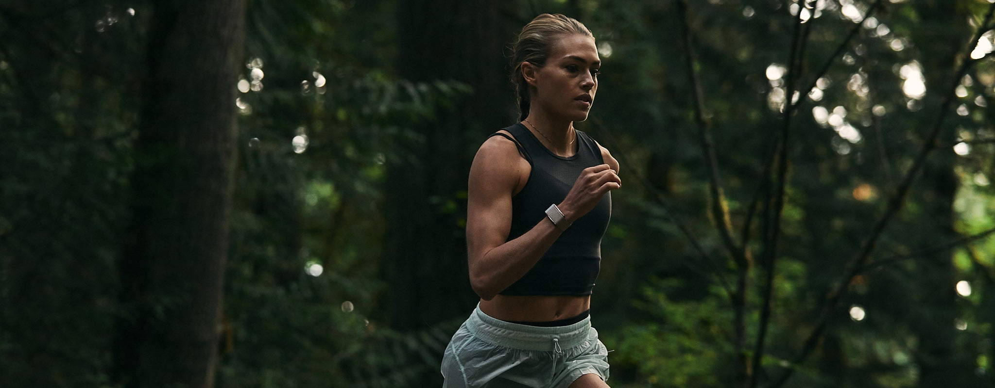 woman jogging through the woods